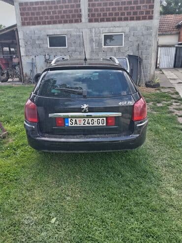 auto otpad audi sabac: Peugeot 407 SW karavan u crnoj boji. Vozilo ima krovne nosače i alu — 3