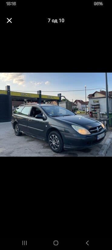Citroen C5 karavan u tamnosivoj boji, sa krovnim nosačima i alu — 2