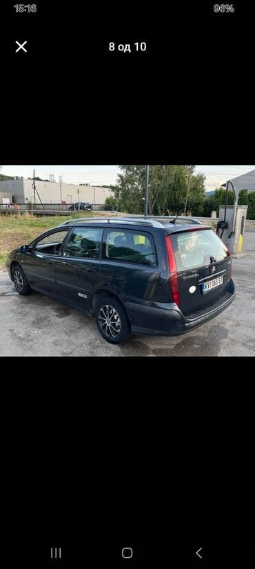 Citroen C5 karavan u tamnosivoj boji, sa krovnim nosačima i alu — 1