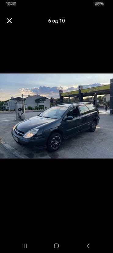 Citroen C5 karavan u tamnosivoj boji, sa krovnim nosačima i alu — 3